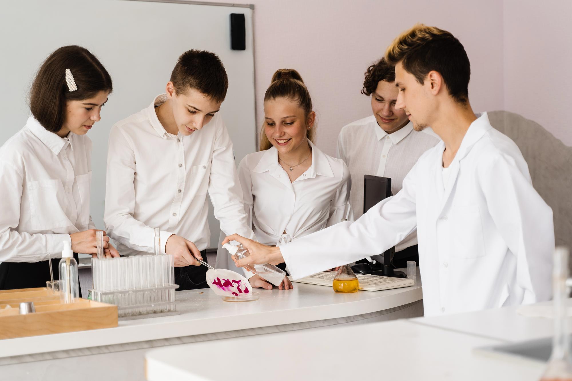 Wide shot of workshop kitchen with students around a counter
